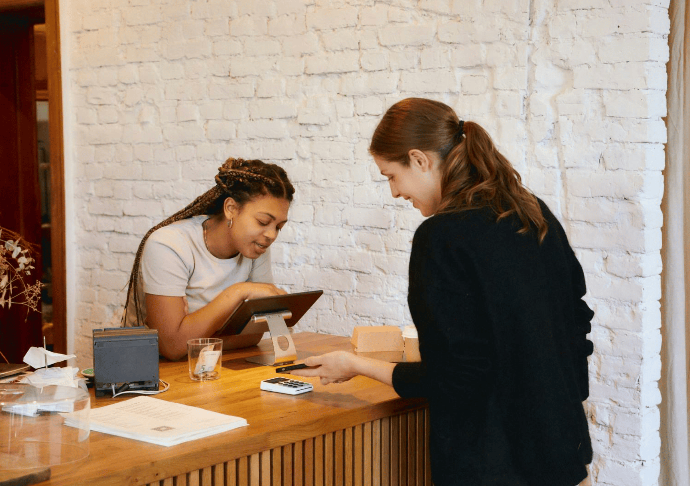 Restaurant counter interaction with payment terminal.