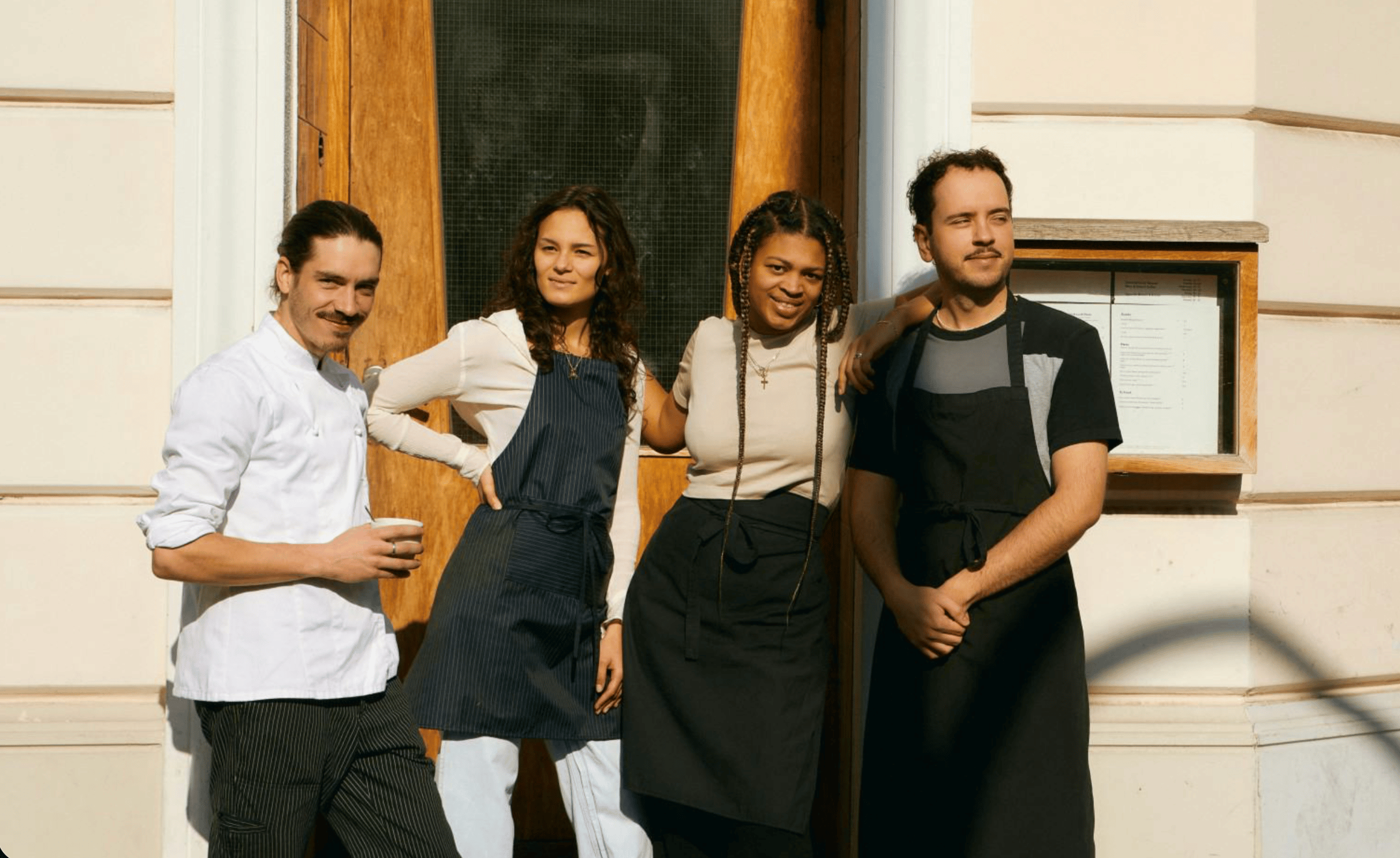Restaurant team standing together outside their venue.